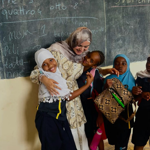 Childcare volunteer organising outdoor play activities in Arusha Tanzania