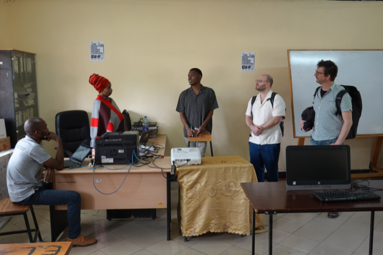 Local NGO staff and volunteers discussing community development projects in Arusha, Tanzania.